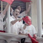 Family and friends celebrate from their Mirador balcony on the streets of Pamplona during the Running of the Bulls