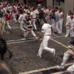 runners and bulls on estafeta street pamplona